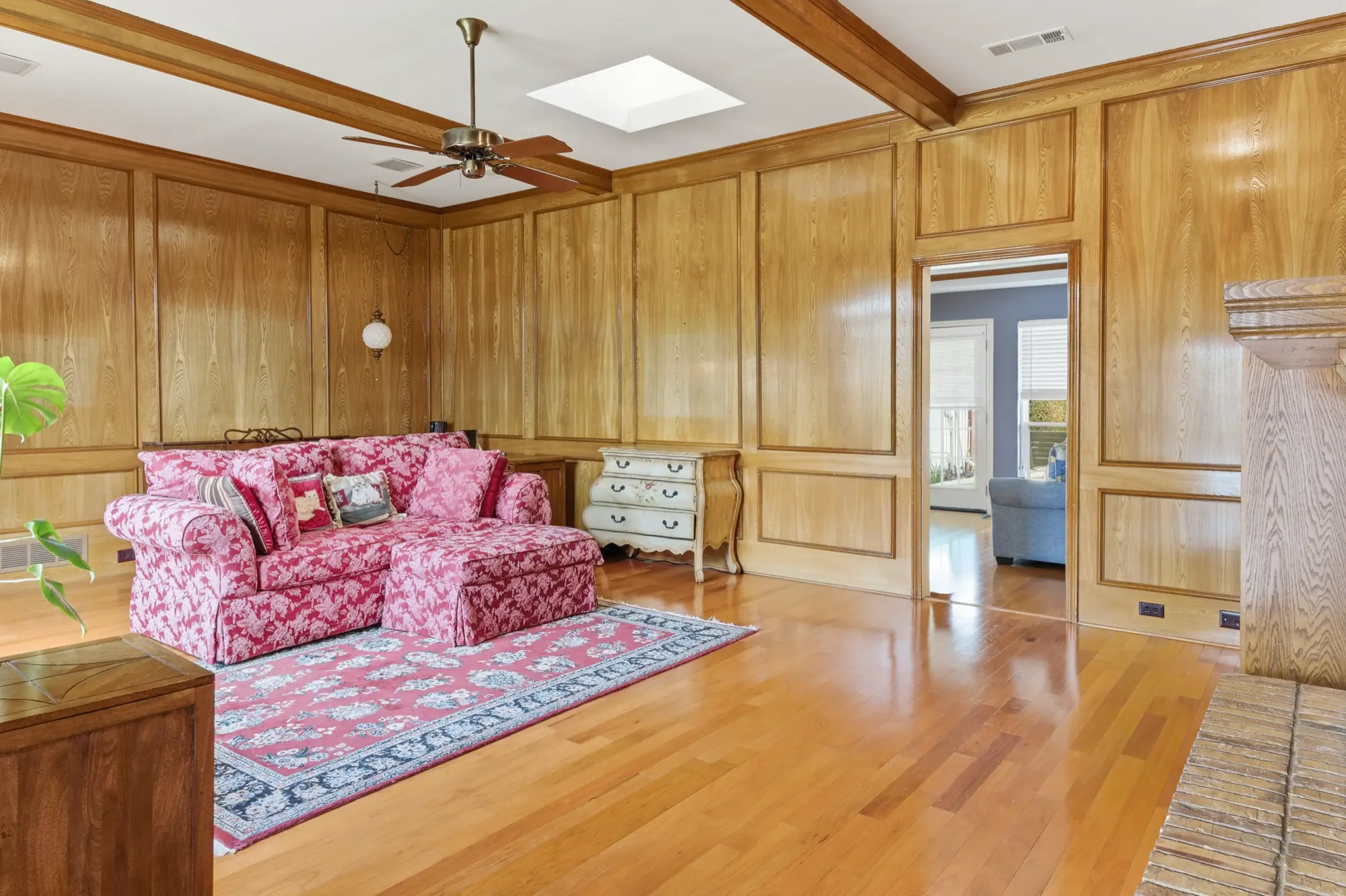 Living room with wood paneling and hardwood floors